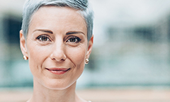 Woman with short, grey hair who want a 401k loan calculator