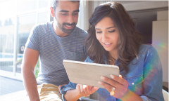 Happy young man who uses a retirement calculator to plan his retirement